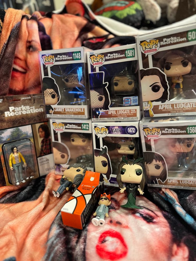 A collection of various figures of Aubrey plaza characters including Funko pops of April Ludgate and Lady Death