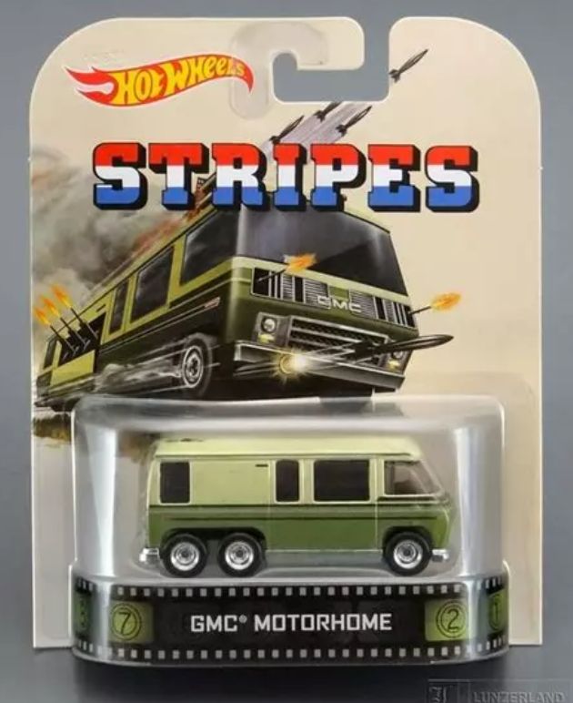 Picture of a package with a toy inside a clear plastic window.  The toy is a hotwheels motorhome toy from the movie Stripes.  The small toy is a light and dark green van with GMC motohome written beneath.  The rest of a package is an illustrated action post of the vehicles with the word Stripes in red, white, and blue, with the Hot Wheels red swoosh logo on the top left.