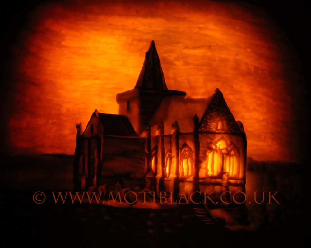 A photo of a pumpkin carving of St Monans Kirk and graveyard.