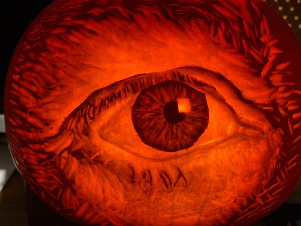 A photo of a pumpkin carving of an eye