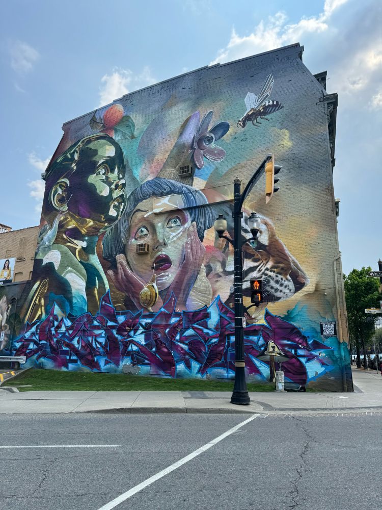 A full length mural covering one entire side of a 3 storey building.