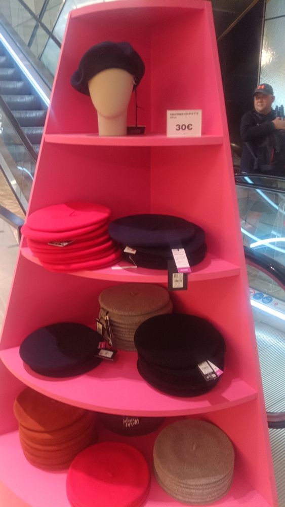 A range of berets of various colours and sizes in a Paris department store