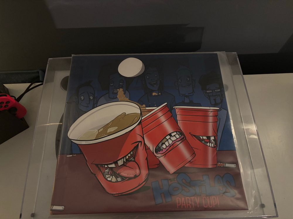 The Hostile EP Party Cup cover on top of a turntable. 