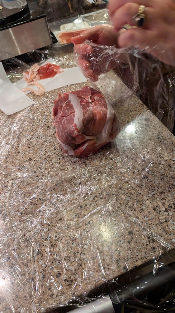 Only prosciutto is now visible, with the duxelles and meat fully wrapped inside.