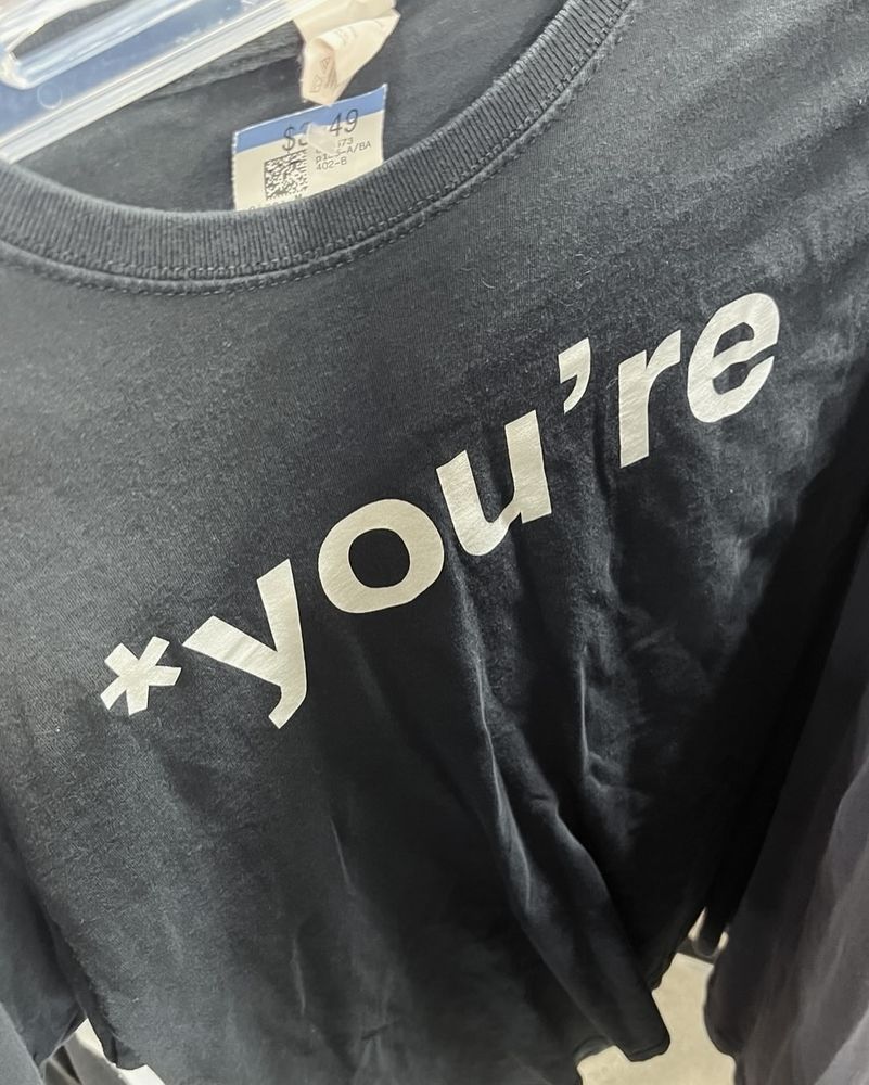 A black t-shirt that reads “*you’re”.