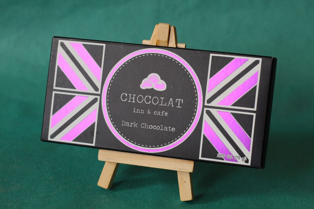 Photo of wrapper for Chocolat Inn & Cafe Dark Chocolate bar on small easel.