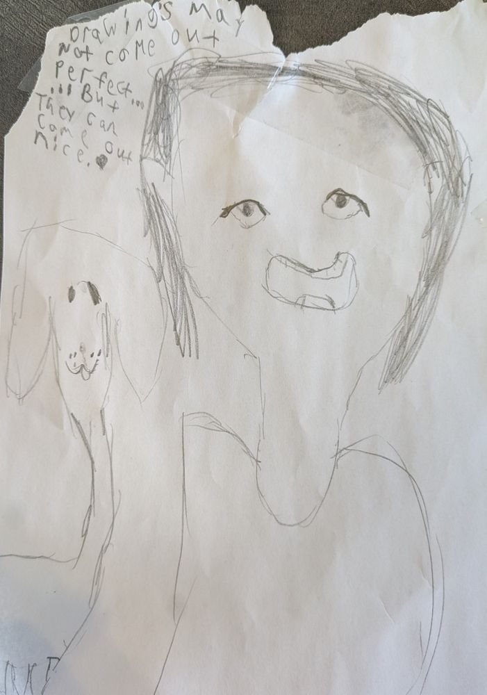 A drawing of a girl and a dog with the following words written in the upper-left corner:
Drawing's may not come out perfect...
...but they can come out nice.