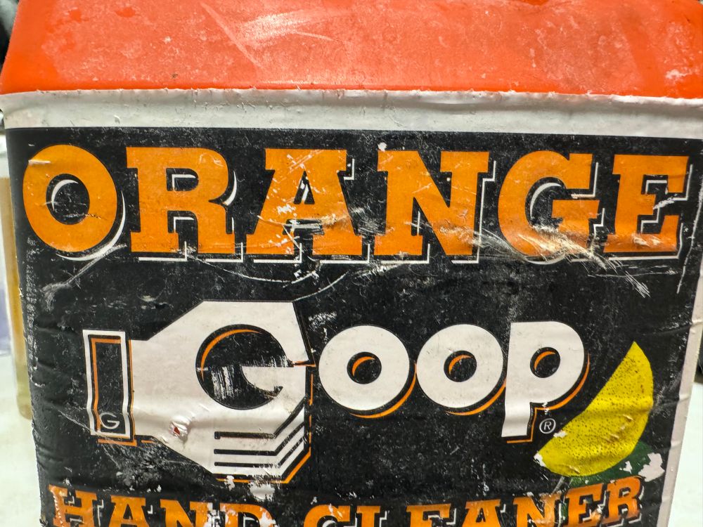 Photo of Orange Goop hand cleaner, which also has a hand that looks like it’s wanking Trump’s mushroom dick.