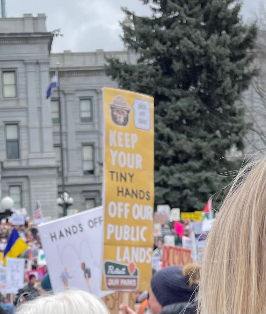 Sign with picture of Smoky the Bear 🐻 reading “Keep your tiny hands off our public lands”