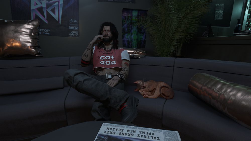 V from cyberpunk 2077 wearing a "Cat Dad" crop top and chilling on a couch next to a sleeping cat