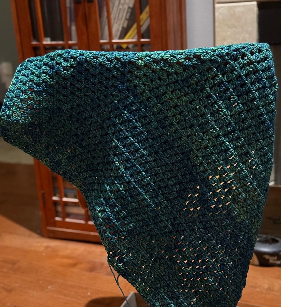Green-blue wool pelegrine, a type of shawl.