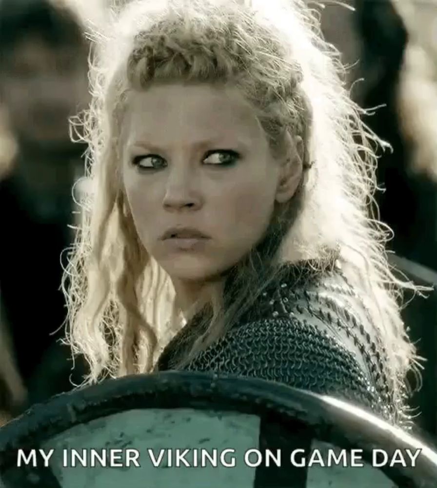 a woman holding a shield with the words " my inner viking on game day " written below her