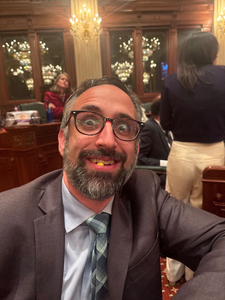 Picture of Leader Guzzardi with bewildered eyes. He has a piece of half eaten candy corn in his teeth. Tie offset. 