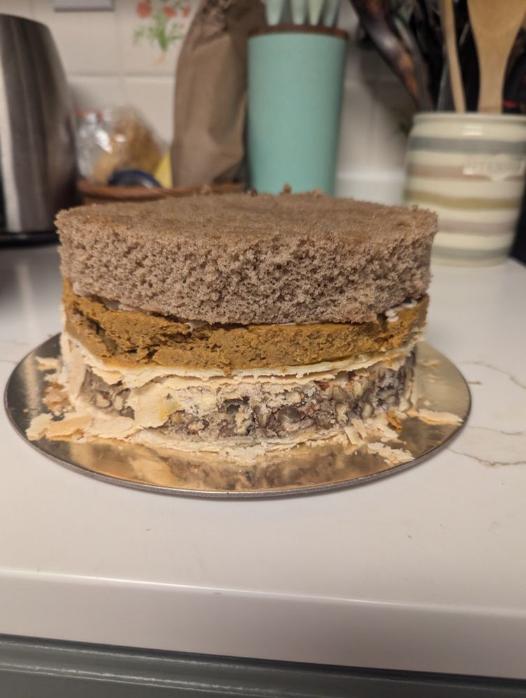 The pecan pie is the bottom tier of the cake, the outer crust and edges cut off. The pumpkin pie is similarly cut and makes the middle tier of the cake. The spice cake is the top tier. 