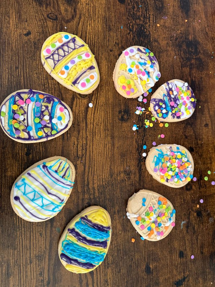 Easter egg cookies decorated with icing and sprinkles.