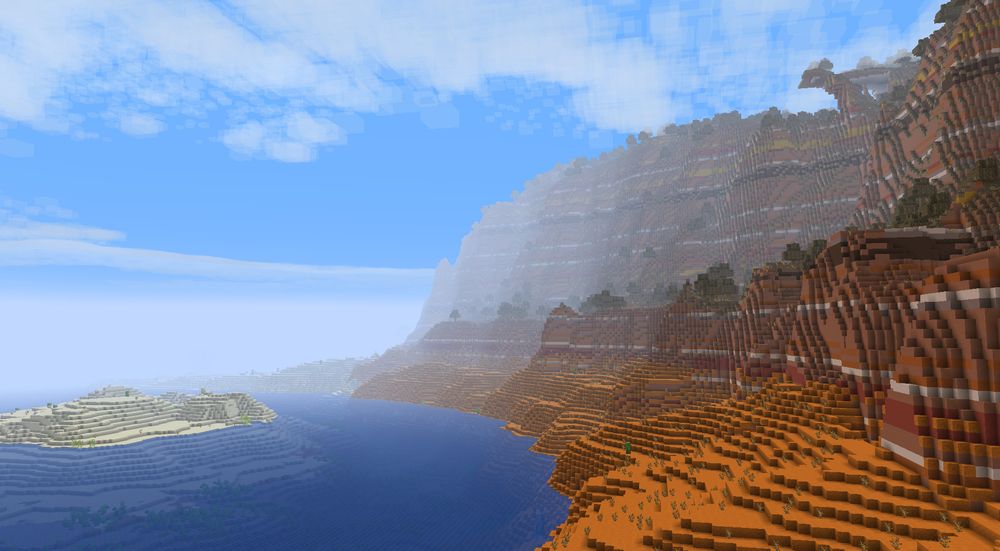 A river with a small desert on the left and a large cliff of badlands on the right