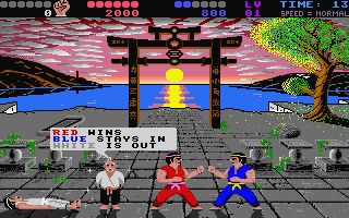 International Karate Plus on the Atari ST. As the sun sets in a salmon pink sky, a bout between three fighters ends. Red and Blue face each other menacingly while White is spark out on the floor. A judge appears to inform us that Red wins, Blue stays in and White is out.