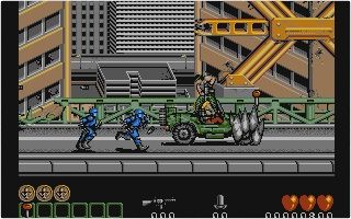 A screenshot of Midnight Resistance on the Atari ST. The player rides a jeep while shooting at enemy robots.