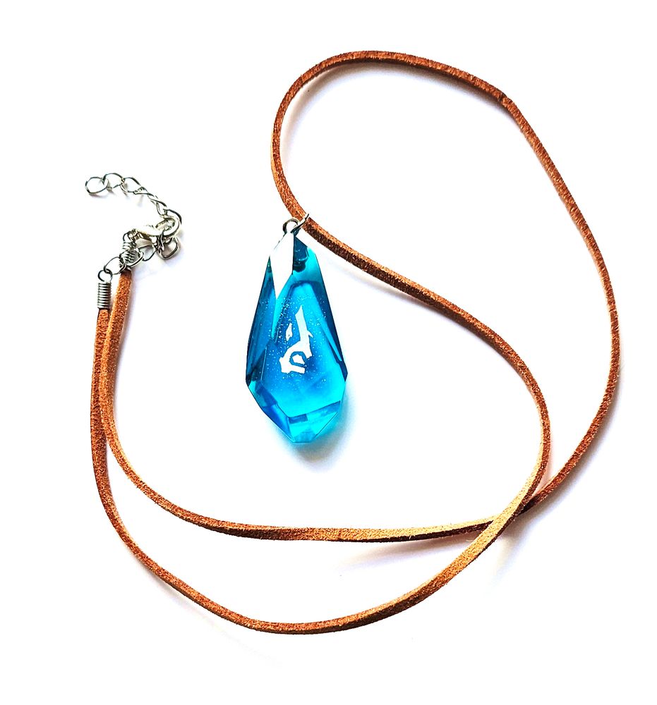 The acceleration rune made in resin with a shiny symbol inside and made as a necklace with a brown cord