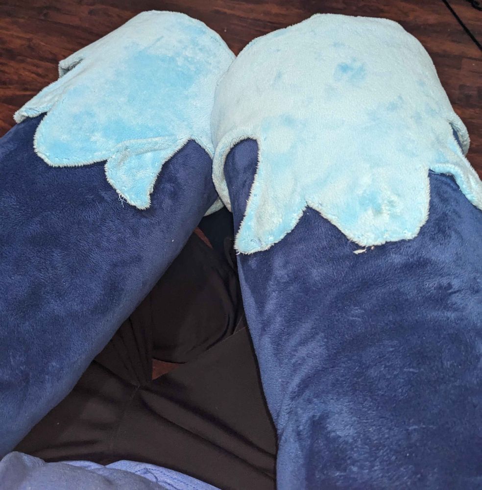 A pair of blue fursuit armhooves