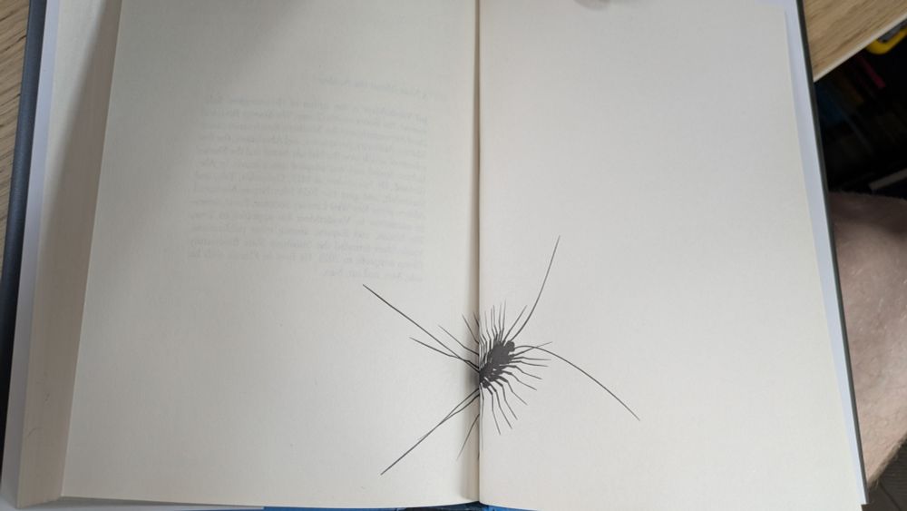 A photo of a book with an illustration of a house centipede
