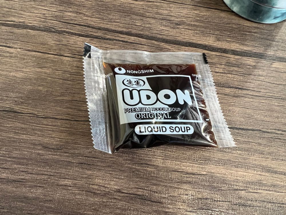 pack of liquid soup base from instant noodles