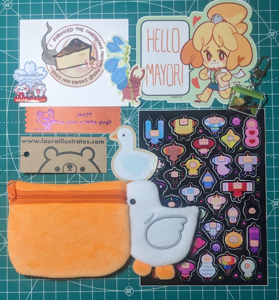 The described swag plus a few gifties. "I survived the cheesecake factory" mini print, SmokuraCon 2025 sticker, and an orange ribbon with Stitches from Animal Crossing saying "me? I'm just a little guy!"