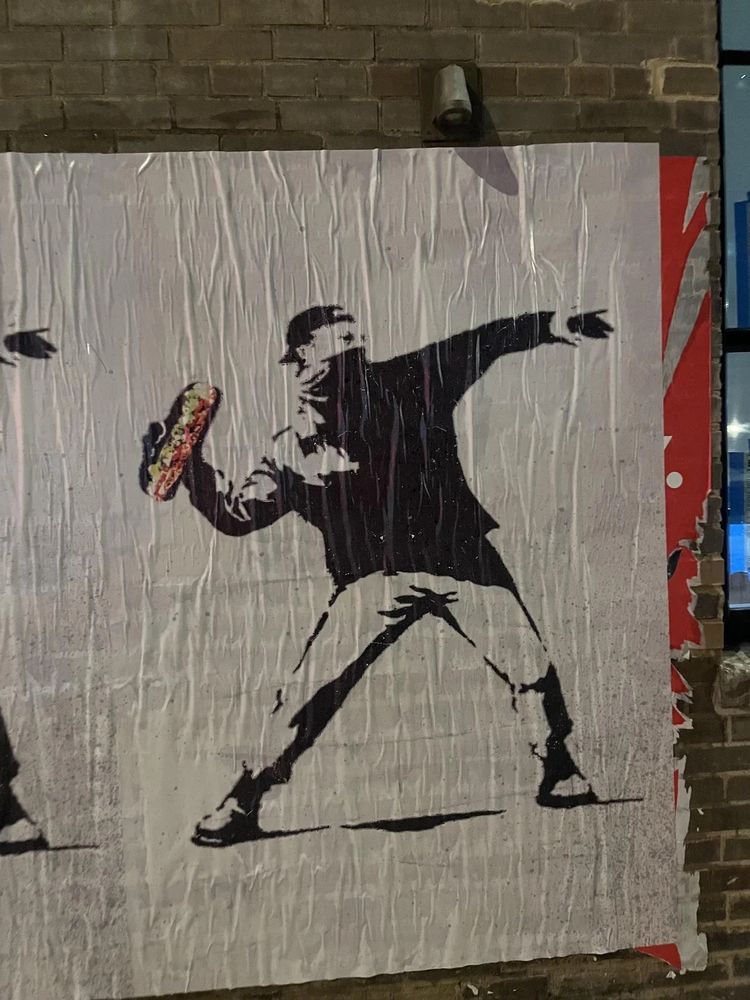 DC Street Art (Banksy-Style) of someone throwing a subway sandwich.
