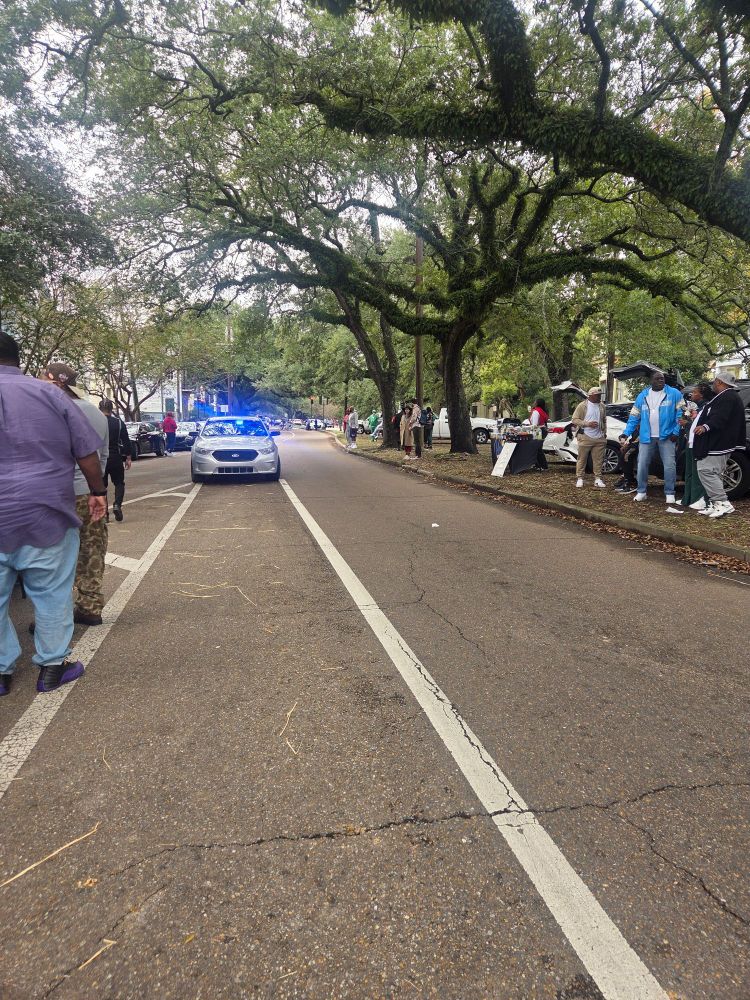 Crowd gathering as a second line approaches. 