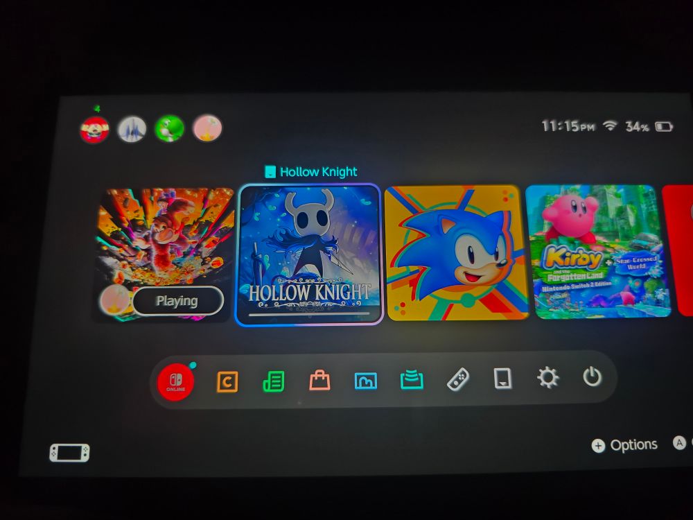 Switch 2 home screen with Hollow Knight downloading
