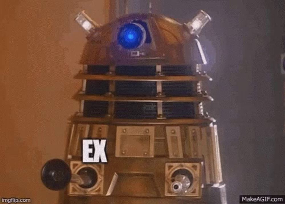 a dalek from doctor who is standing in a dark room and says `` externi '' .