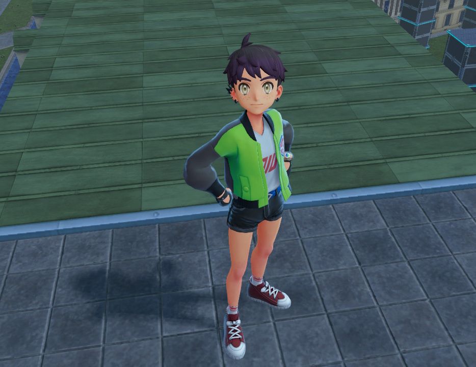 A purple and black haired Pokemon trainer standing with hands on his hips on a rooftop. He has black lightning bolt style earrings, gloves, and short shorts, a green jacket with black sleeves, white socks with red stripes near where you put your feet in, and red canvas shoes.