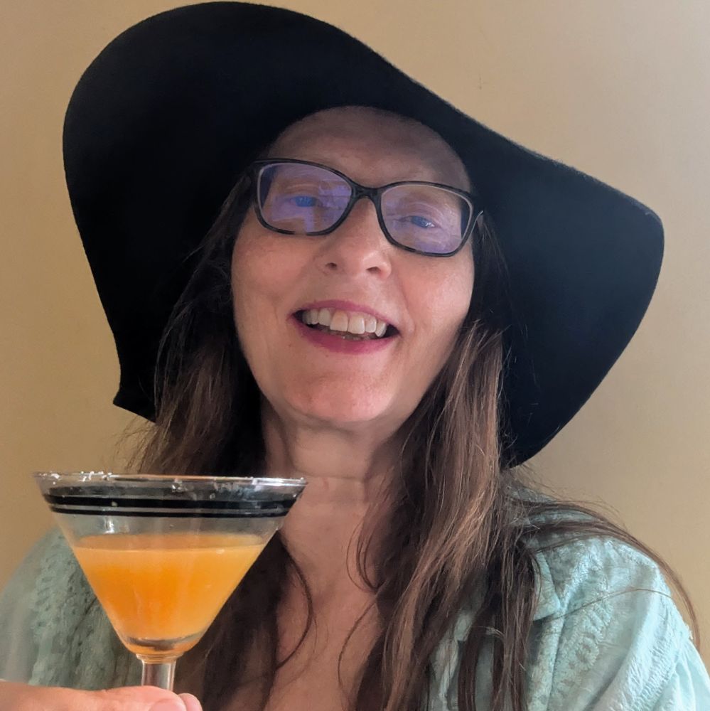 AA Abbott with hat, sunglasses and cocktail.