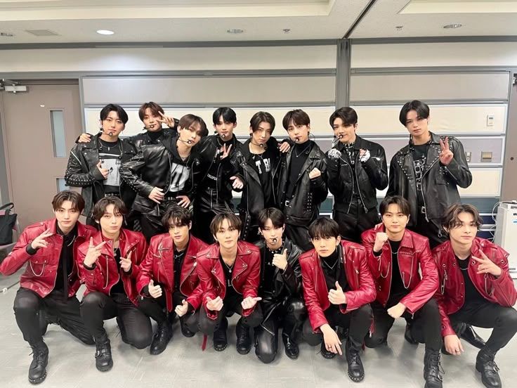 enhypen and &team group photo
all the enhypen members are wearing red jackets and all &team members are wearing black jackets 