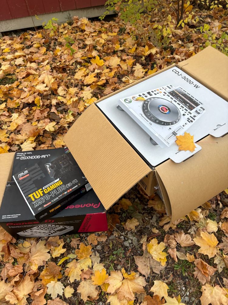 Three boxes for dj equipment on the ground in an alley that I googled that appears to be worth around $5,000 combined 