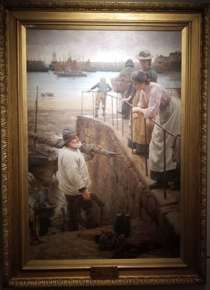 Between the Tides, a painting of a Cornish fisherman talking to two women leaning over a railing in the harbour.