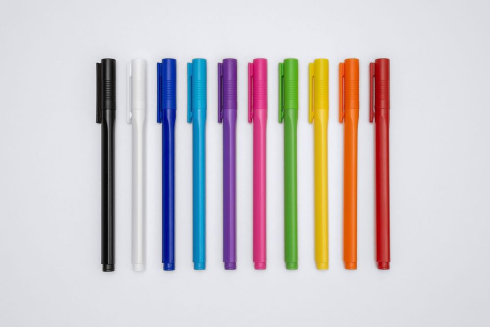 a row of ten pens of all colours from black to red