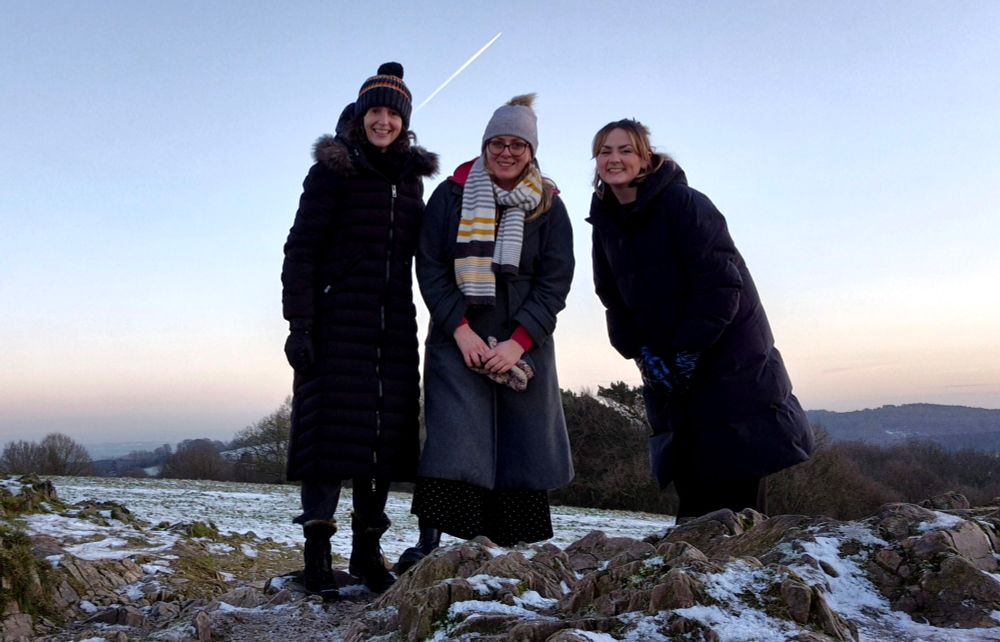 Liz Stokoe, Tilly Flint, Katie Seabridge at the Beacon standing on snowy rocks 