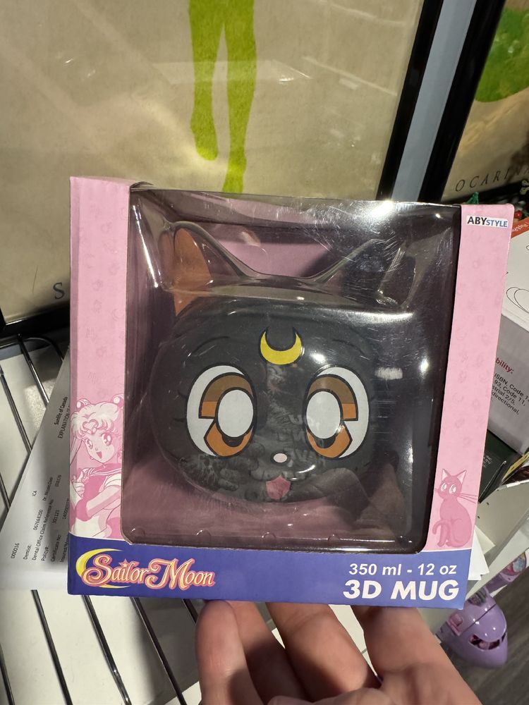 A Sailor Moon Luna-themed coffee mug with lid