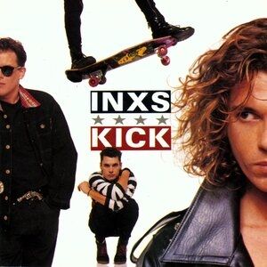 The front cover of Kick, the 1987 INXS album, showing some members of the band in various poses & positions in the foreground & background, including one's feet on a skateboard at the top of the cover, placed like he's jumping over the others.