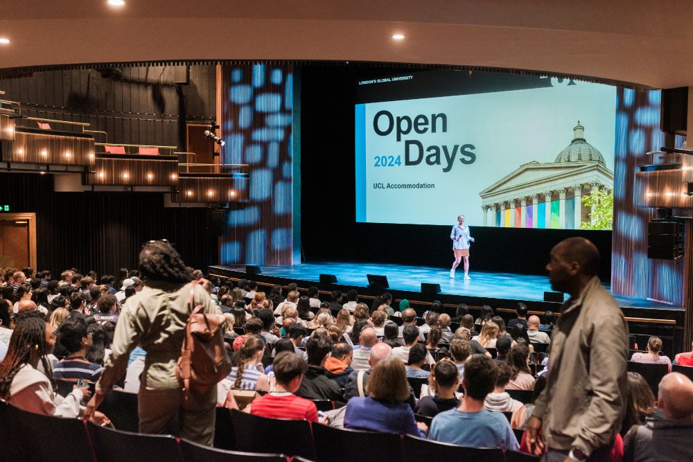Audience watches a presentation on "Open Days 2024 UCL Accommodation" in a lecture theatre.
