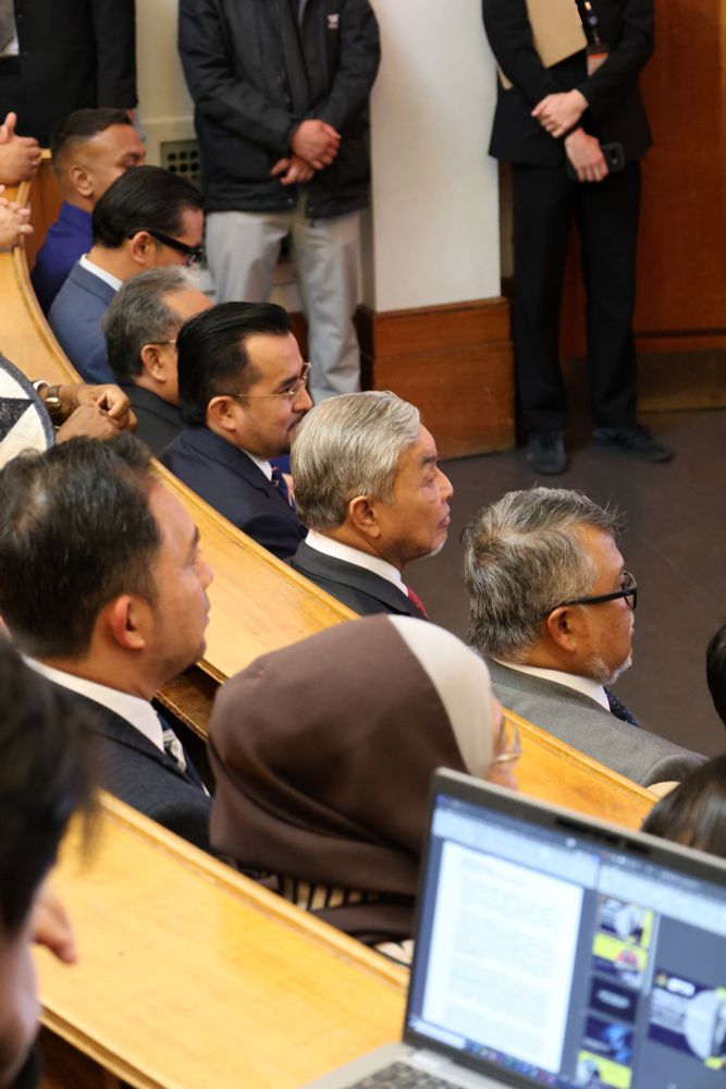 Audience members sitting in rows at a formal event, including former Malaysian Deputy Prime Minister, listening attentively.