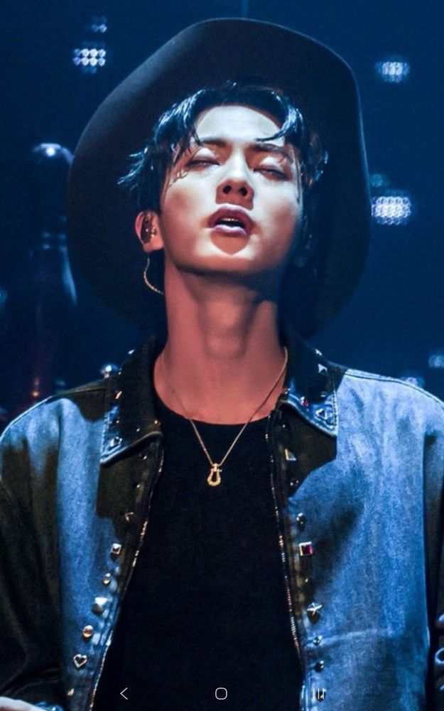 Black hair Jin in a black jacket, T and cowboy hat is on stage for his performance of "Rope It", head thrown back, eyes closed. Yeehaw!
