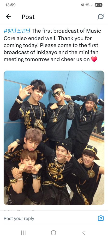 All 7 Bangtan members sre posing in their black debut outfits behind the scenes in this screenshot from X/Twitter.
The (translated) caption is "The first broadcast of Music Core also ended well! Thank you for coming today! Please come to the first broadcast of Inkigayo and the mini fanmeeting tomorrow and cheer us on 🩷