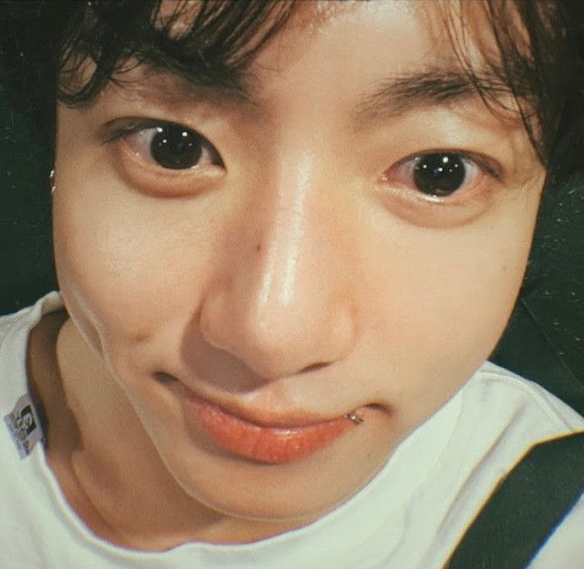 Very close-up pic (selfie?) of JK with dark hair from the era with one lip piercing, his eyes are huge and shiny