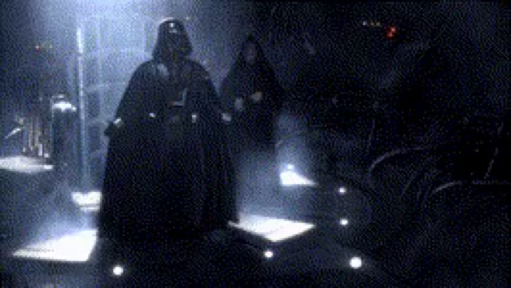 darth vader is walking in a dark room with a group of people