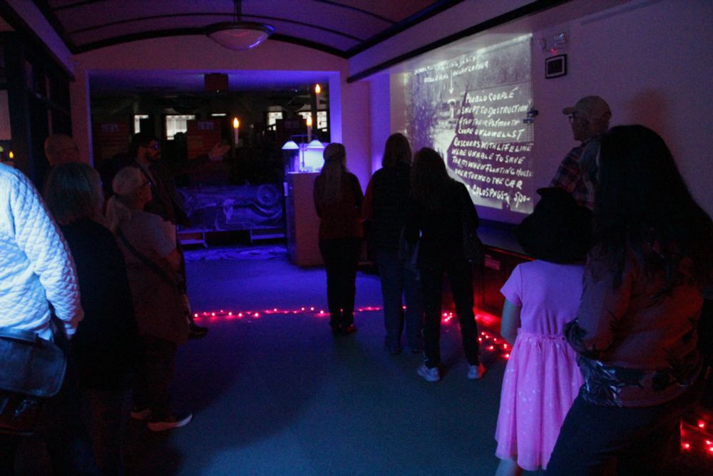 A tour group pauses in the staff area downstairs in Regional History & Genealogy to learn something from Pikes Peak region history. 