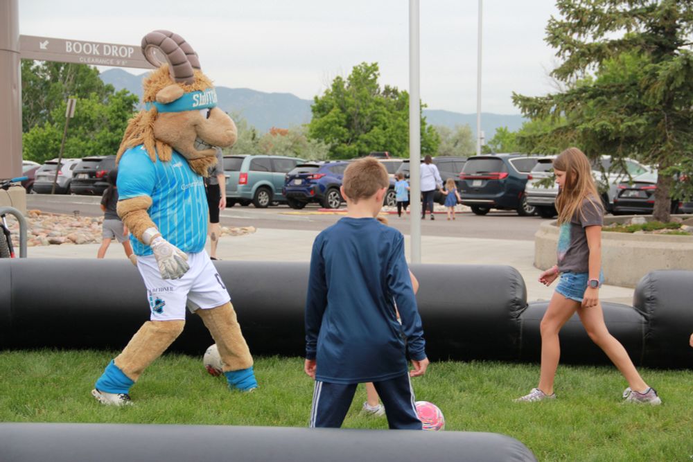 Ziggy plays soccer with kids at the Library. 