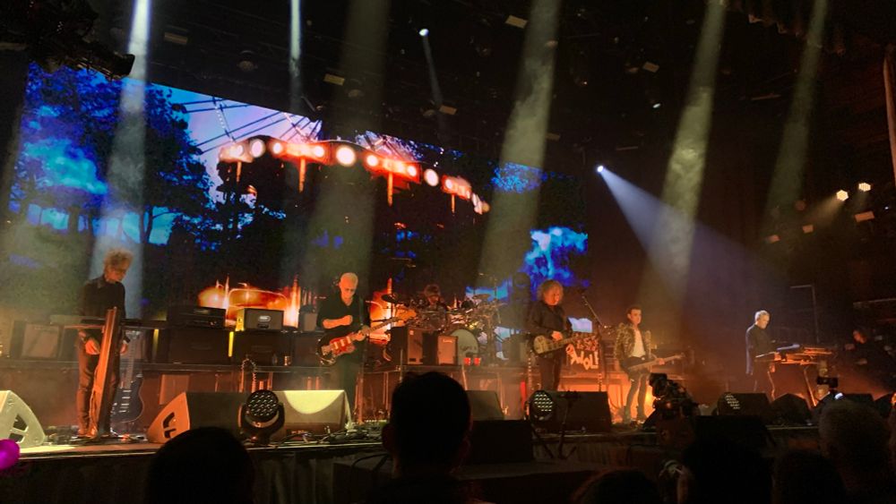 The Cure’s current lineup of (from left to right) Perry Bamonte, Reeves Gabrels, Jason Cooper, Robert Smith, Simon Gallup, and Roger O’Donnell performing at the Troxy in London