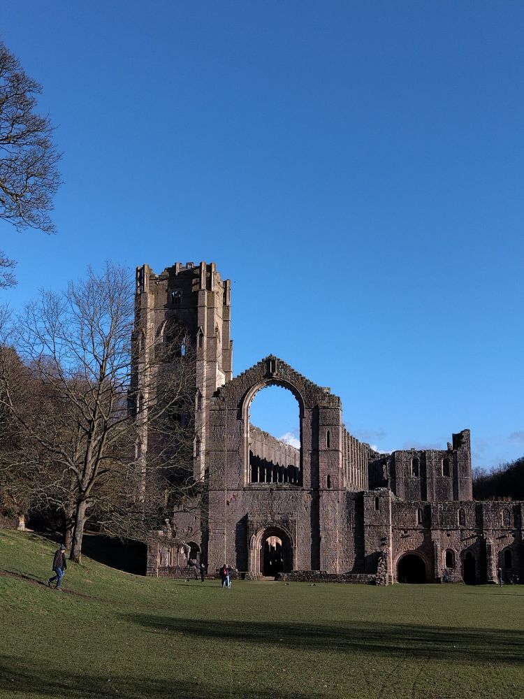 Ruins of a medieval abbey against a blue sky